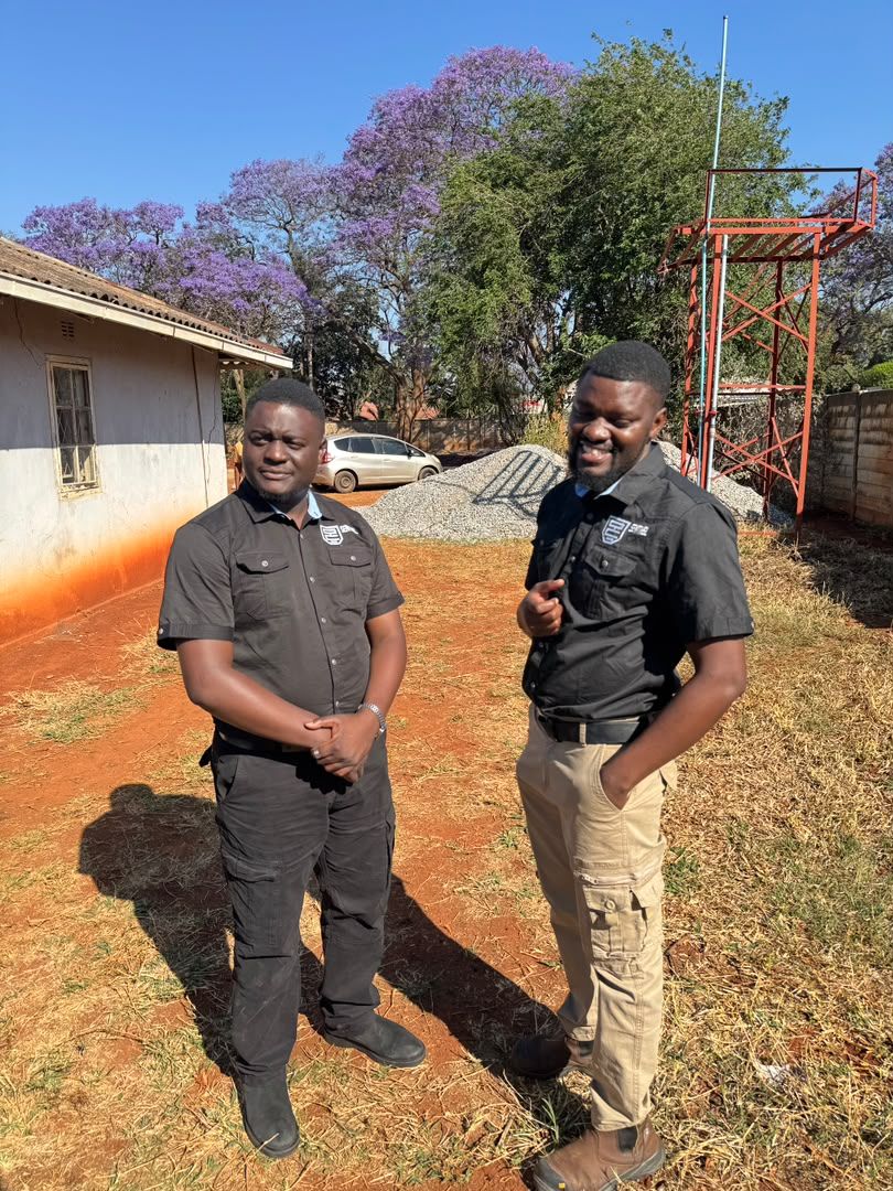 Two Sentinel staff talking through a site under construction